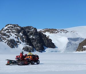 Two expeditioners on quads on the sea ice