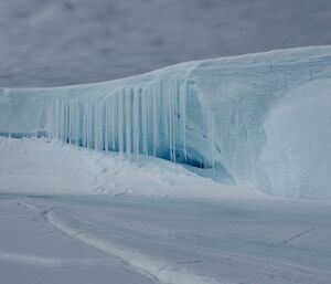 The entrance to an iceberg cave festooned with icicles