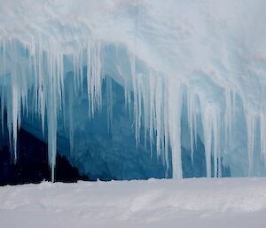 Icicles adorning the entrance to a cave in an iceberg