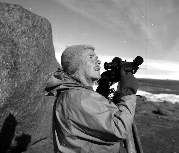 Weather observer, Bob Dingle, using a theodolite near Mawson Station in February 1955.