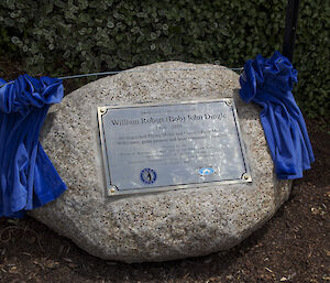 Bob Dingle’s brass memorial plaque attached to a boulder of Tasmanian granite.