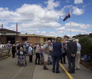 People milling around Bob Dingle’s memorial plaque.