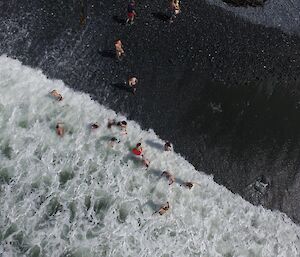 An aerial view of the surf rolling in on Macquarie Island team’s Australia Day swim