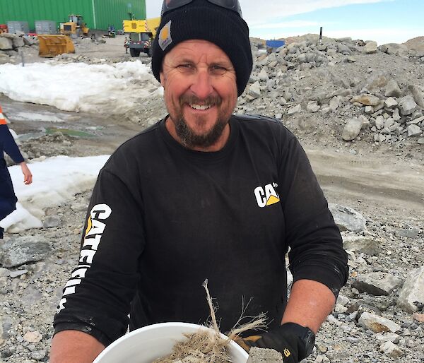 Man holding bucket of rubbish