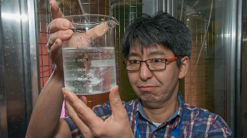 Krill biologist Dr So Kawaguchi with a beaker of krill