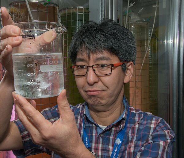 Krill biologist Dr So Kawaguchi with a beaker of krill