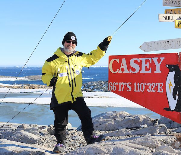 Speculative fiction author Sean Williams beside the Casey station sign.