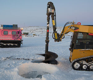 Machine drilling hole in sea ice