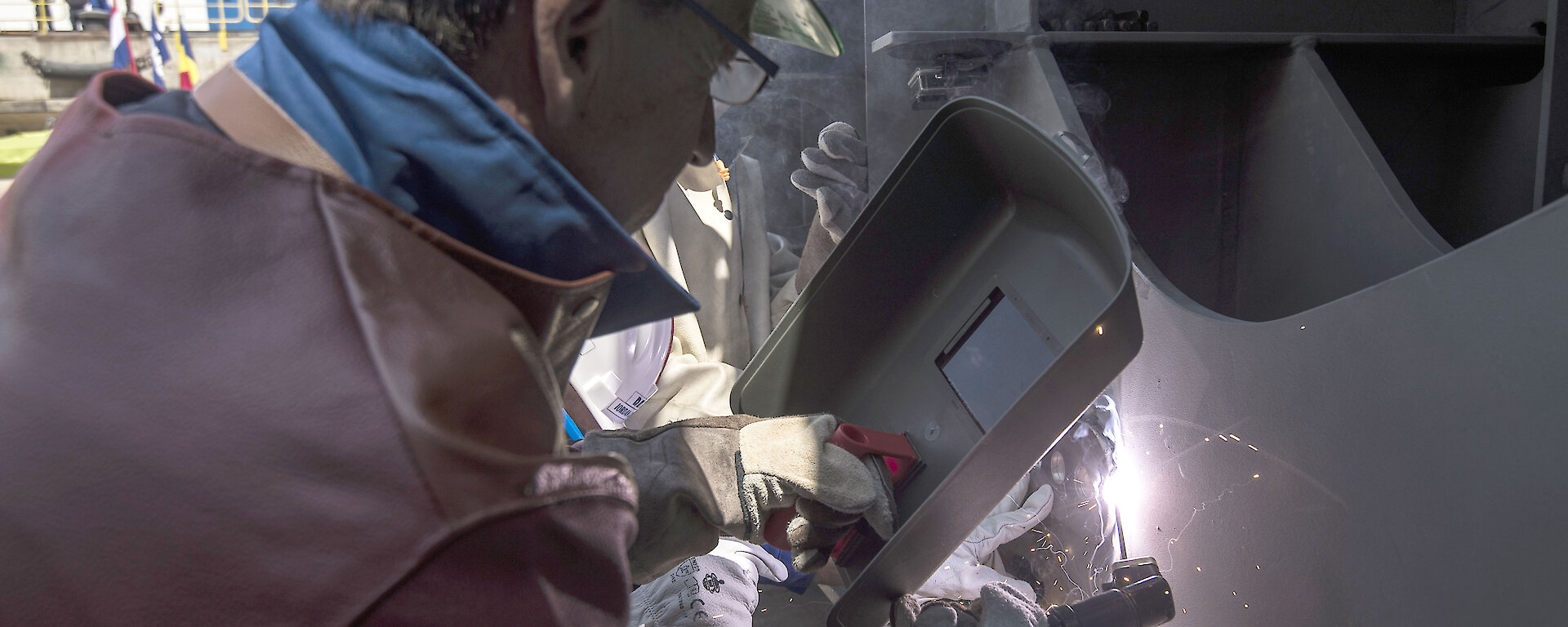 photo of man welding coins