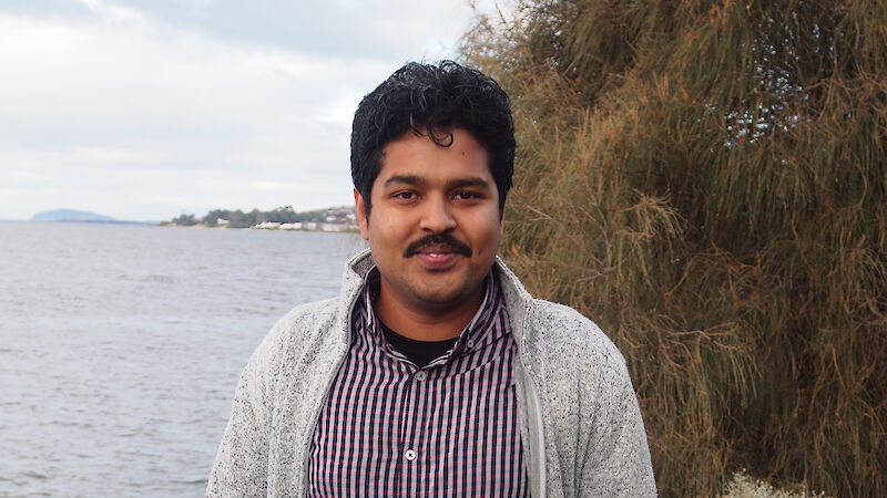 Dr Bishakhdatta Gayen standing beside the Derwent River in Hobart.