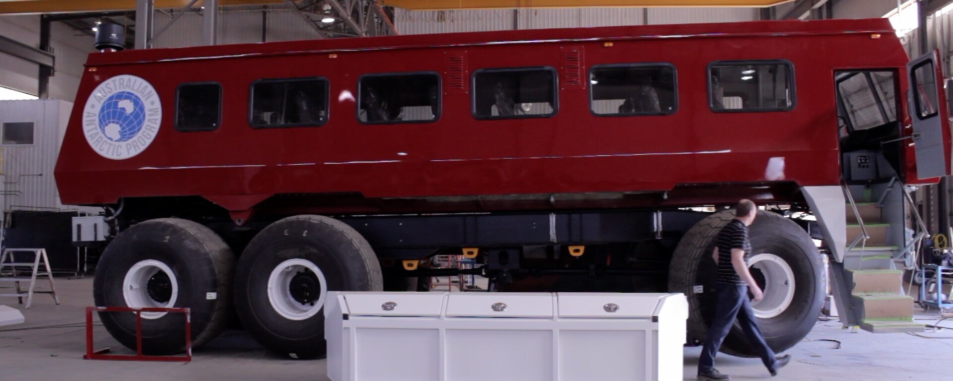 Bus in a workshop with a man walking past