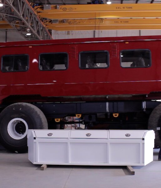 Bus in a workshop with a man walking past
