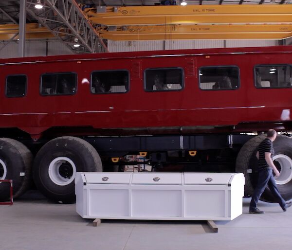 Bus in a workshop with a man walking past