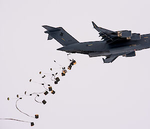 plane dropping load of cargo