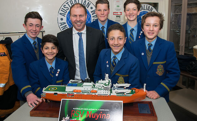 Students posing with Minister and model ship