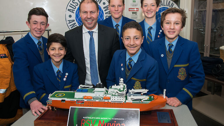 Students posing with Minister and model ship