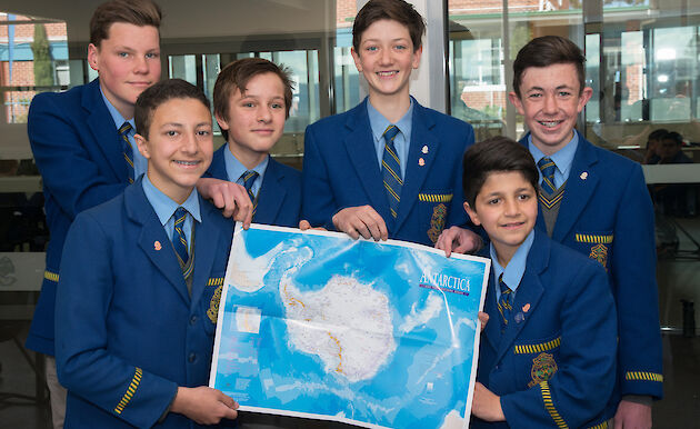Students with a map of Antarctica