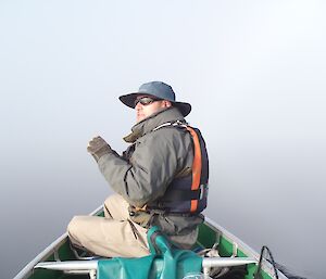 Martin Walch paddling kayak through fog.