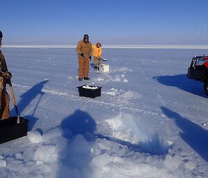 Three men patch up a hole in Wilkins runway.