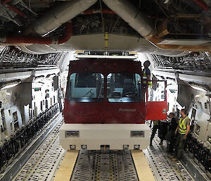 Large bus in the back of a cargo plane