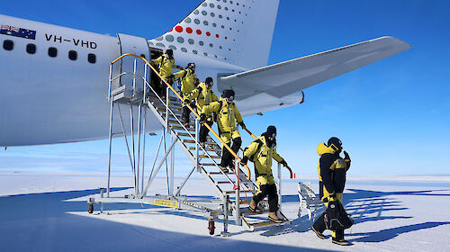 Photo of people getting off a plane.