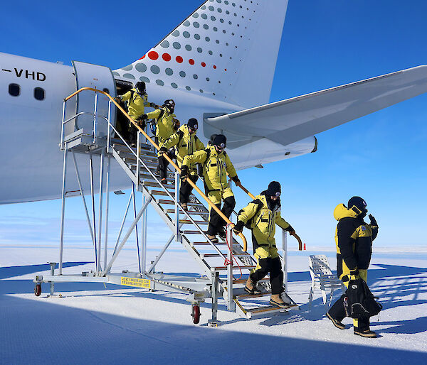 Photo of people getting off a plane.