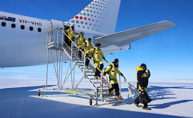 Photo of people getting off a plane.