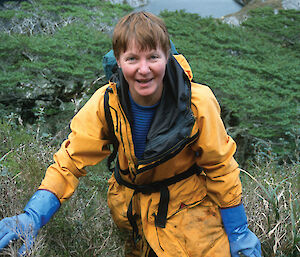 Dr Barbara Wienecke climbing a hill on Diego de Almagro, Argentina, to reach an albatross colony.