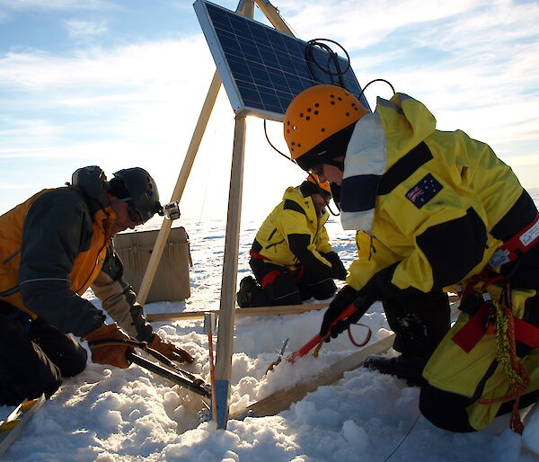 Dr Sue Cook (right) and two helpers install the GPS and solar panels on the Sørsdal Glacier in 2015–16.