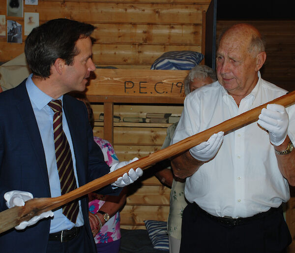 Charlton Clark hands over the flagpole to David Jensen