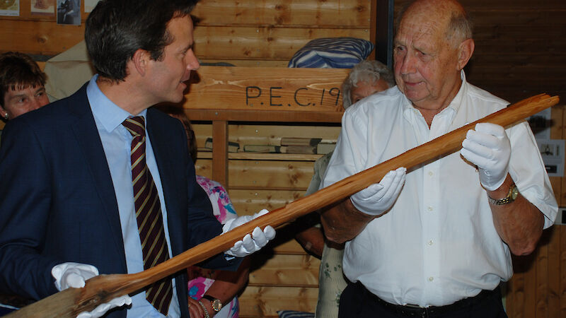 Charlton Clark hands over the flagpole to David Jensen