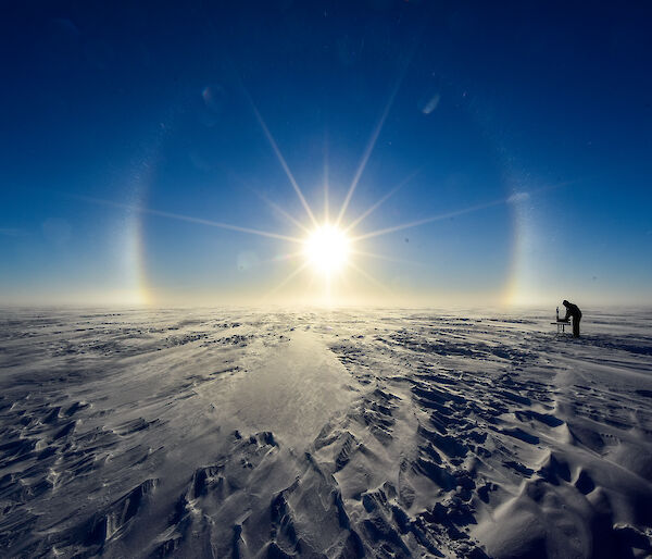Scientists at work in the glow of a solar halo at Law Dome.