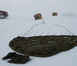 Parachute and cargo on ground before it was packed up ready for transport to station.