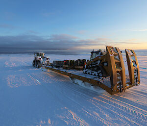 Cargo being transferred to station with a tractor and sled.