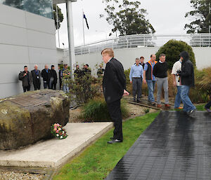 Acting Director Rob Wooding lays a wreath Memorial Rock at Kingston headquarters in memory of Antarctic personnel who have lost their lives on the icy continent.