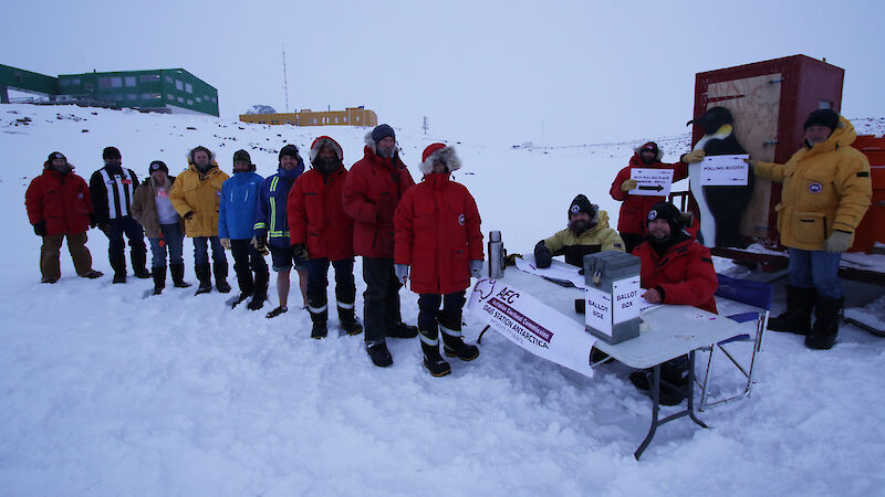 Expeditioners at Davis research station standing in line to vote at an election polling station on the sea ice.