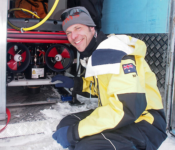 Man posing with remotely operated vehicle.