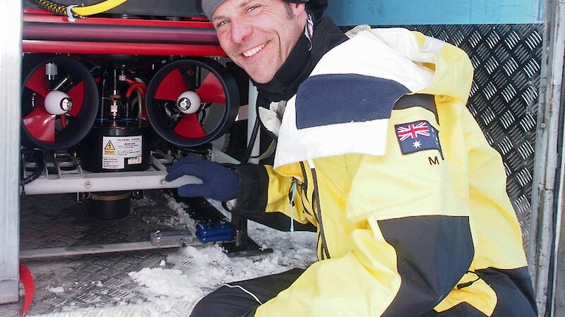 Man posing with remotely operated vehicle.