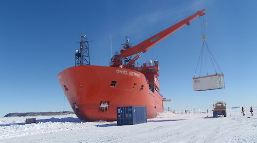 The Aurora Australis unloading cargo on the sea ice at Davis.