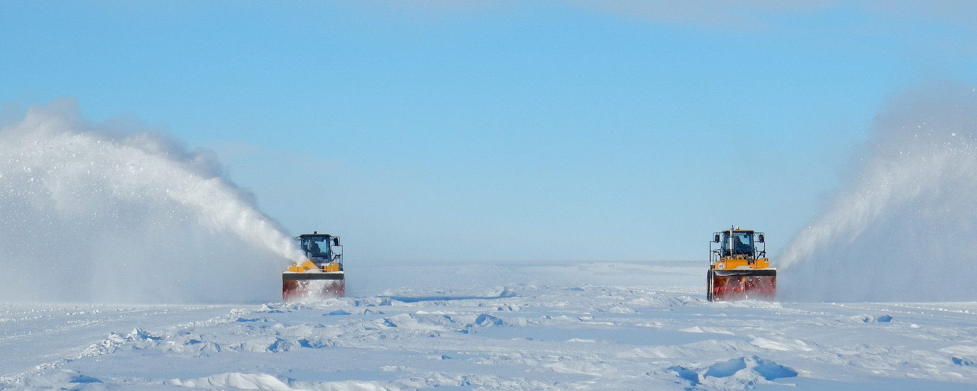 Snow blowers removing the winter snow accumulation