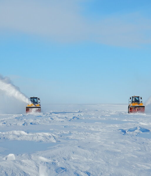 Snow blowers removing the winter snow accumulation