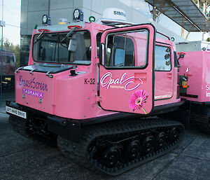 A pink Hägglunds vehicle in front of the Antarctic Division in Kingston Tasmania