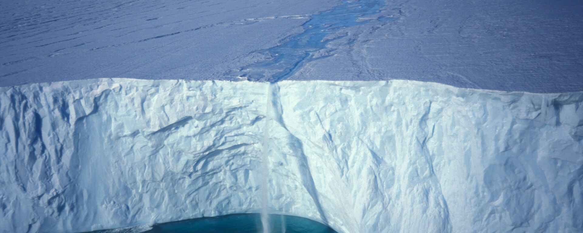 Melt water falling over ice cap