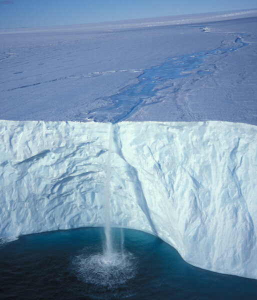 Melt water falling over ice cap
