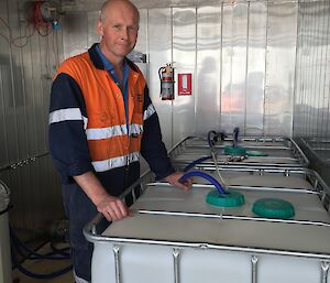 Krill biologist Rob King with the containers in which the krill will be flown back to Australia
