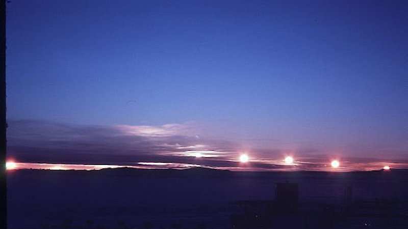 Timelapse photo of midnight sun skimming across horizon