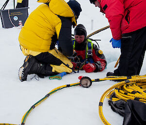 A diver prepares for an icy dive