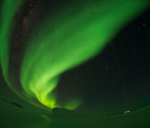 A green aurora over Davis station, intersected by the green laser beam from the stations light detection and ranging instrument.