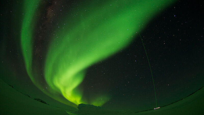 A green aurora over Davis station, intersected by the green laser beam from the stations light detection and ranging instrument.