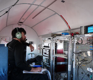 Scientist operating the ice penetrating radar on the Basler aircraft